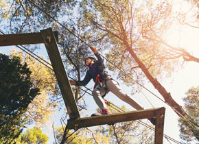 an adult shown from above walking through a challenge course